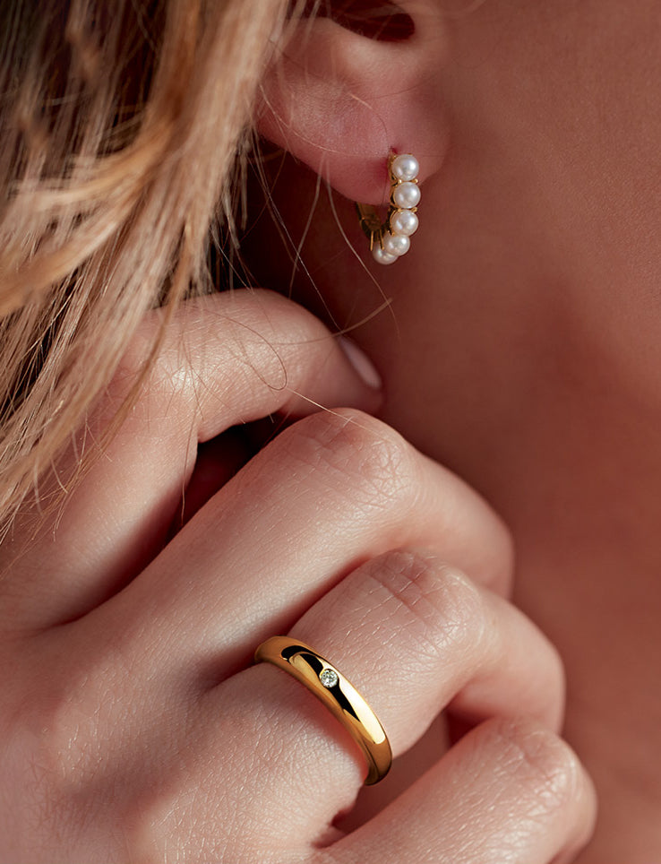 woman wearing Petite Dome Ring and pearl, gold hoop earrings 