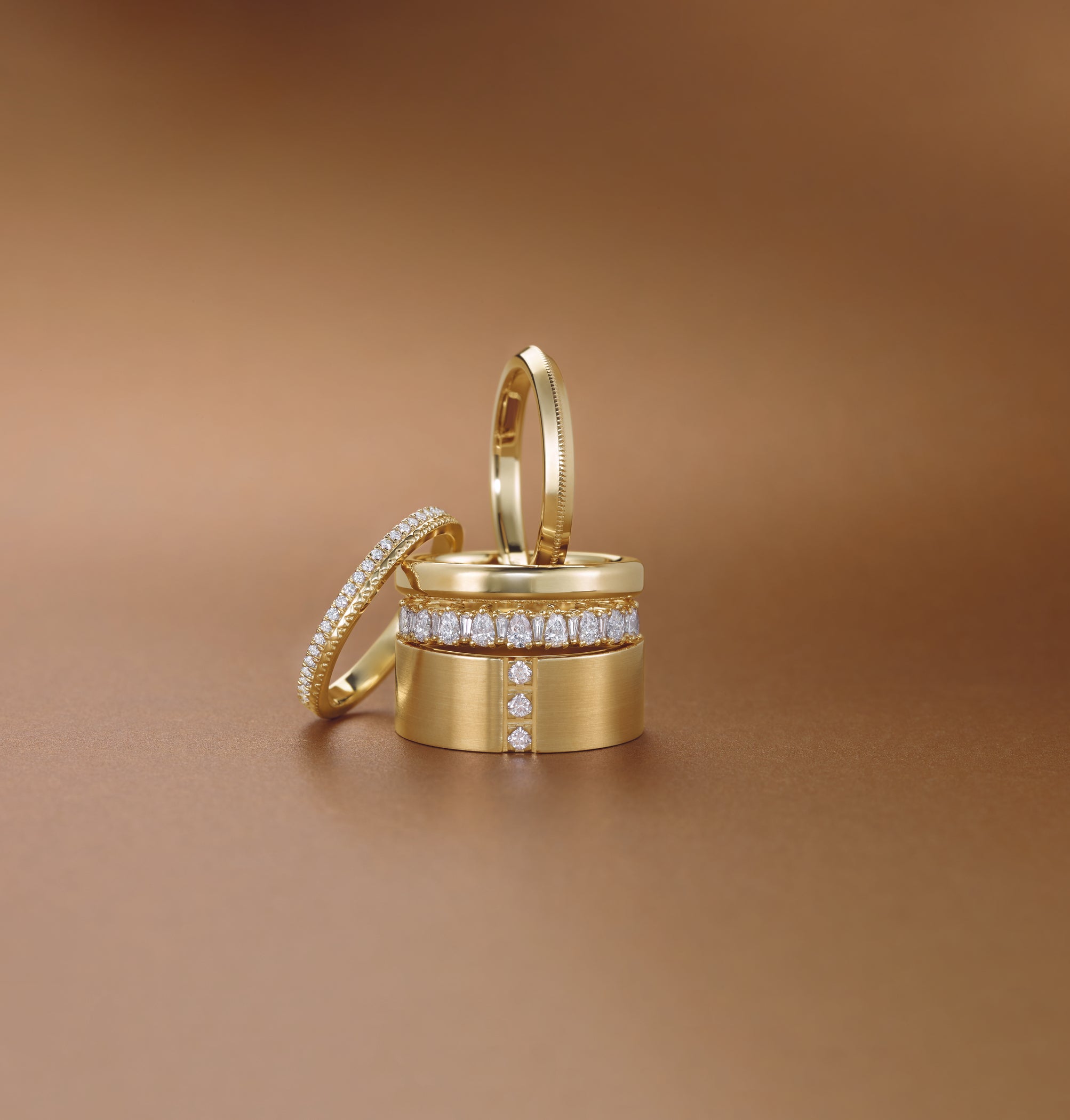variety of gold and diamond rings stacked