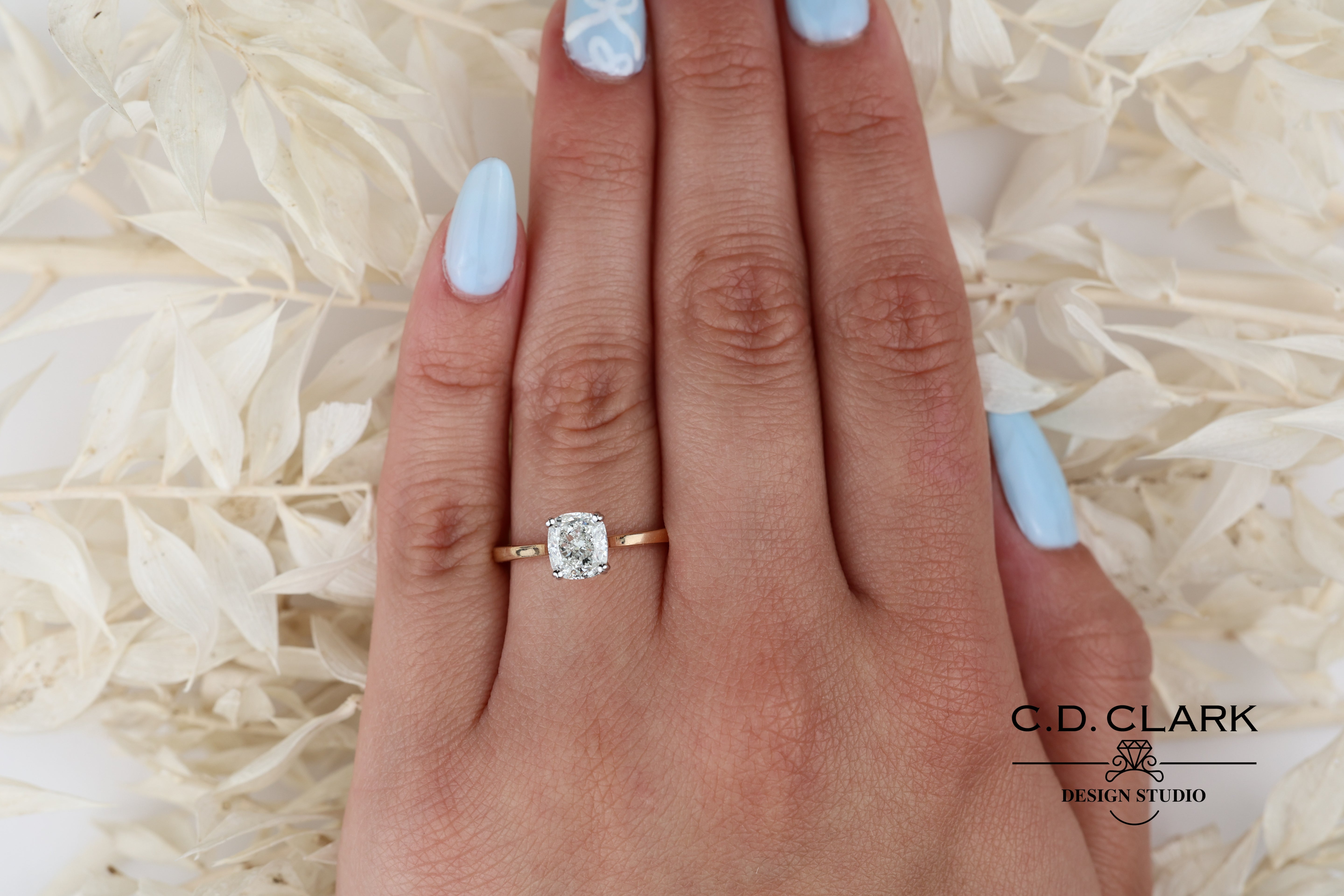 Shimmering brilliance awaits in this stunning 14kt Gold Band, featuring a dazzling 1.55 ct Cushion