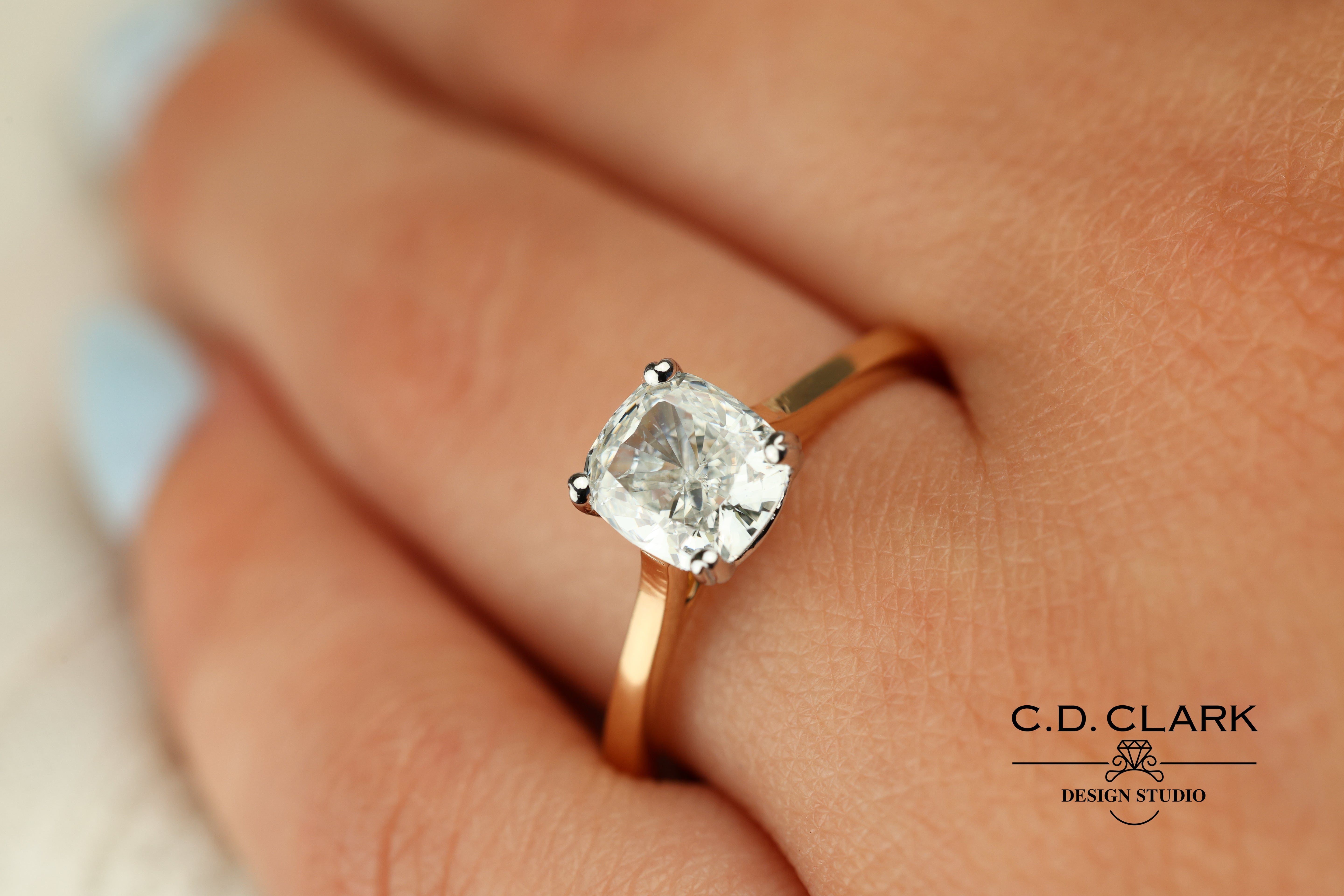 Shimmering brilliance awaits in this stunning 14kt Gold Band, featuring a dazzling 1.55 ct Cushion