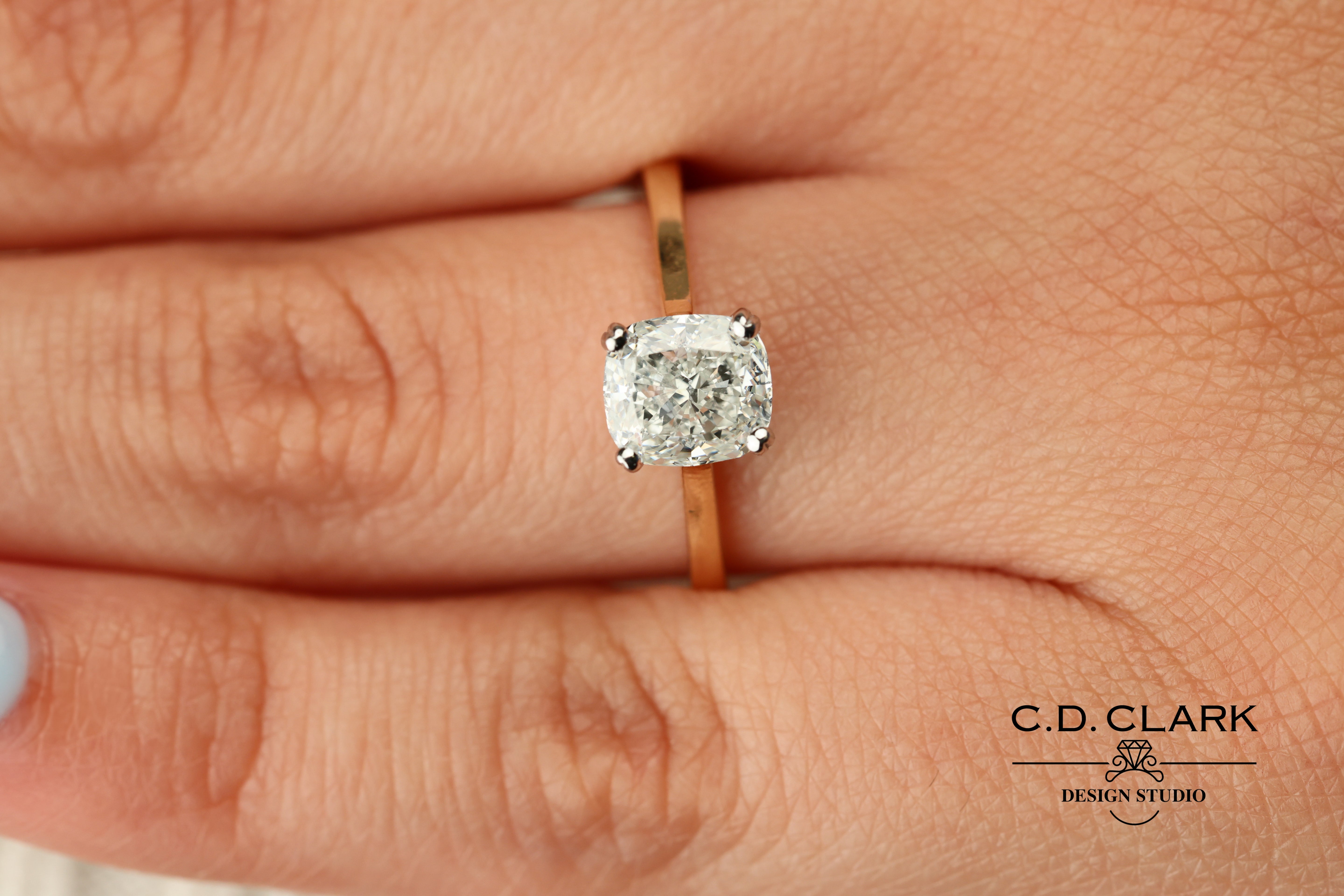 Shimmering brilliance awaits in this stunning 14kt Gold Band, featuring a dazzling 1.55 ct Cushion