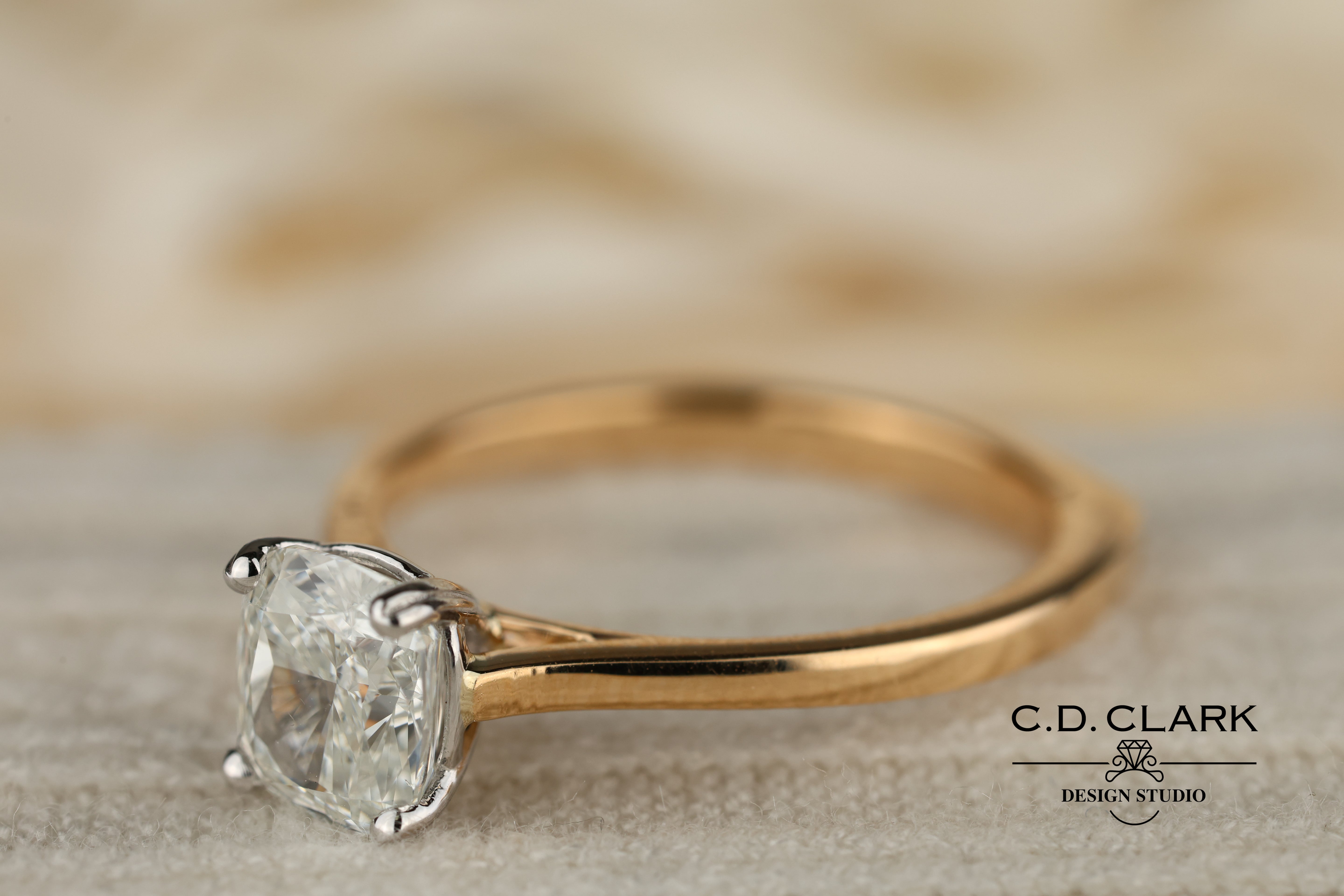 Shimmering brilliance awaits in this stunning 14kt Gold Band, featuring a dazzling 1.55 ct Cushion