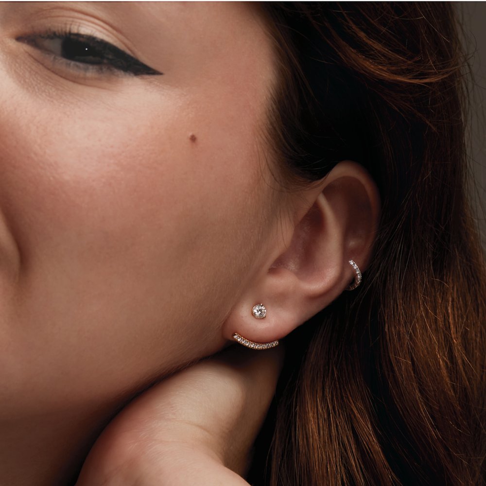 woman wearing 14K yellow gold hoops featuring lab-grown diamonds