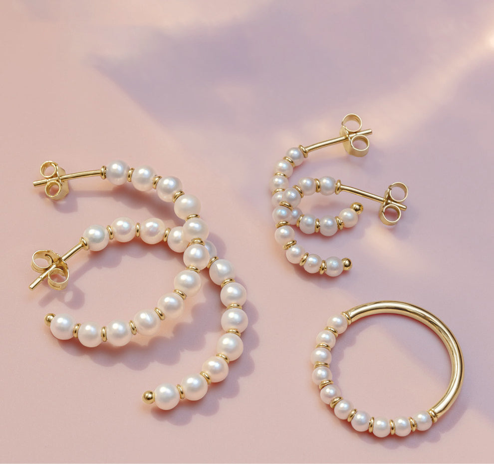 yellow gold and pearl earrings and ring