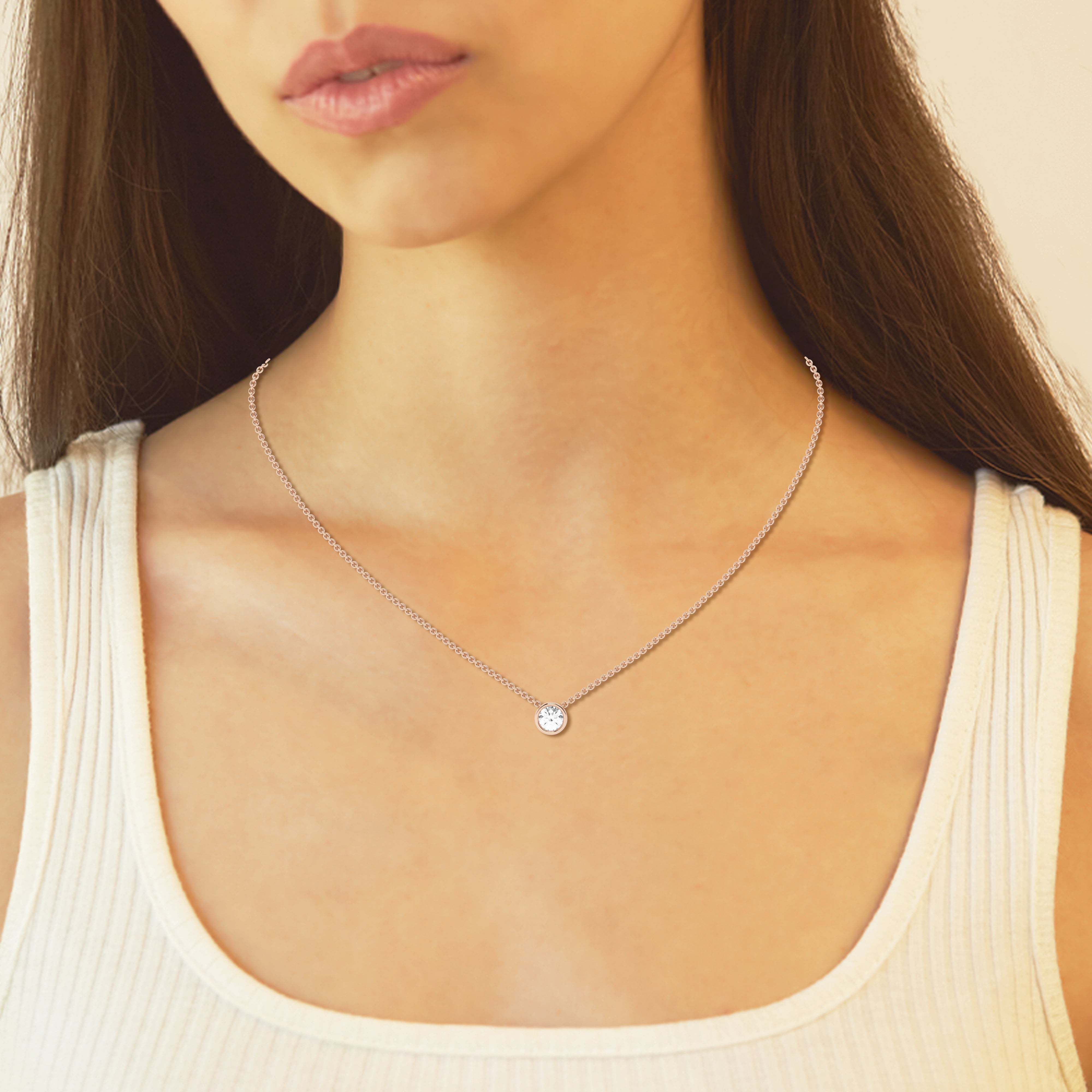 woman wearing White gold bezel pendant showcasing a 0.5 carat lab-grown diamond