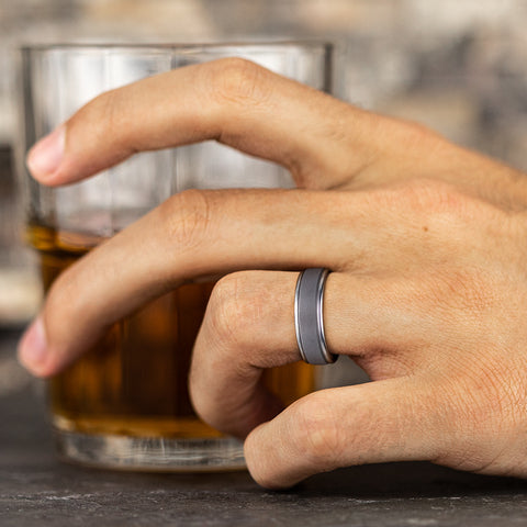 man wearing tantalum grey wedding ring with polished round edges