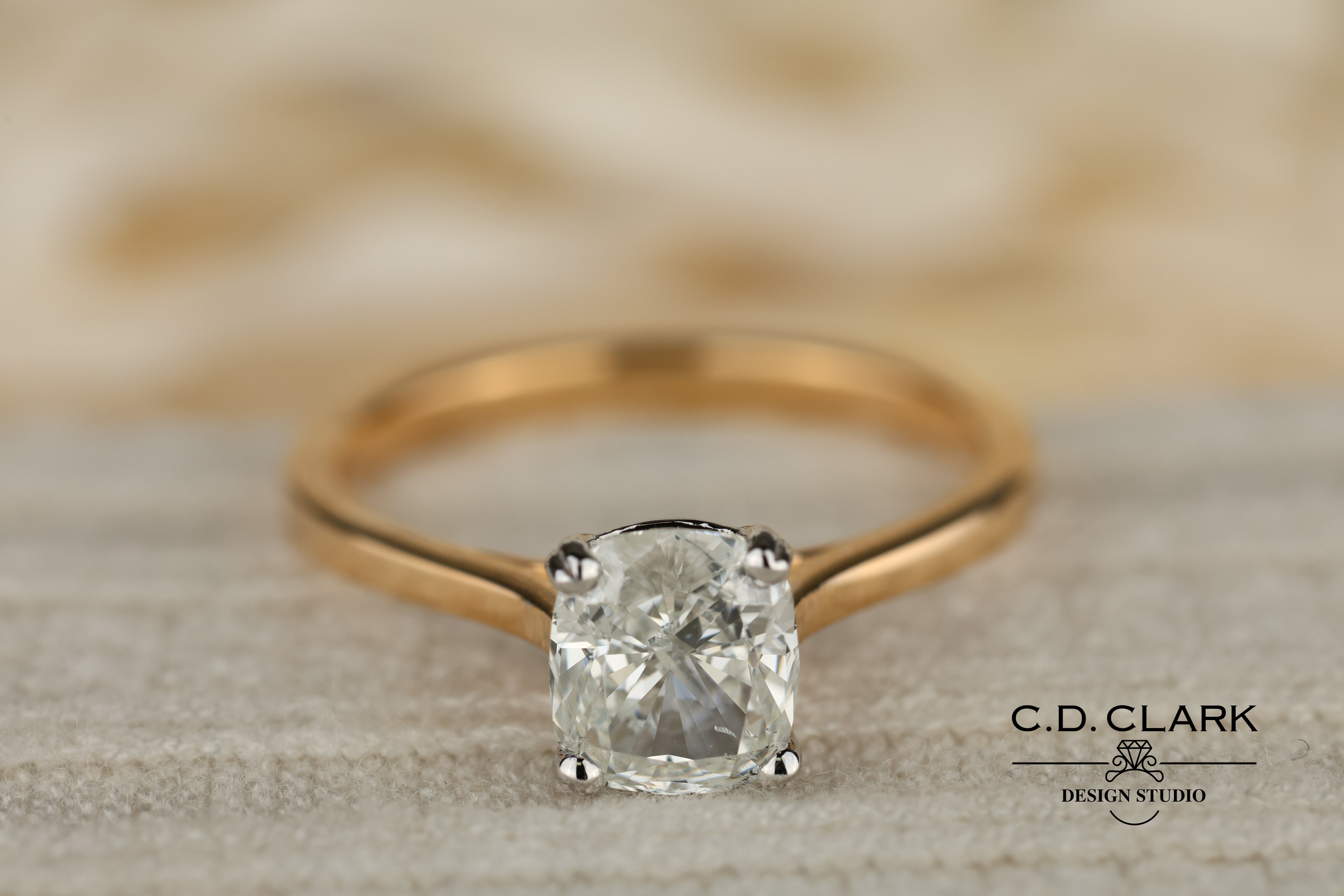 Shimmering brilliance awaits in this stunning 14kt Gold Band, featuring a dazzling 1.55 ct Cushion