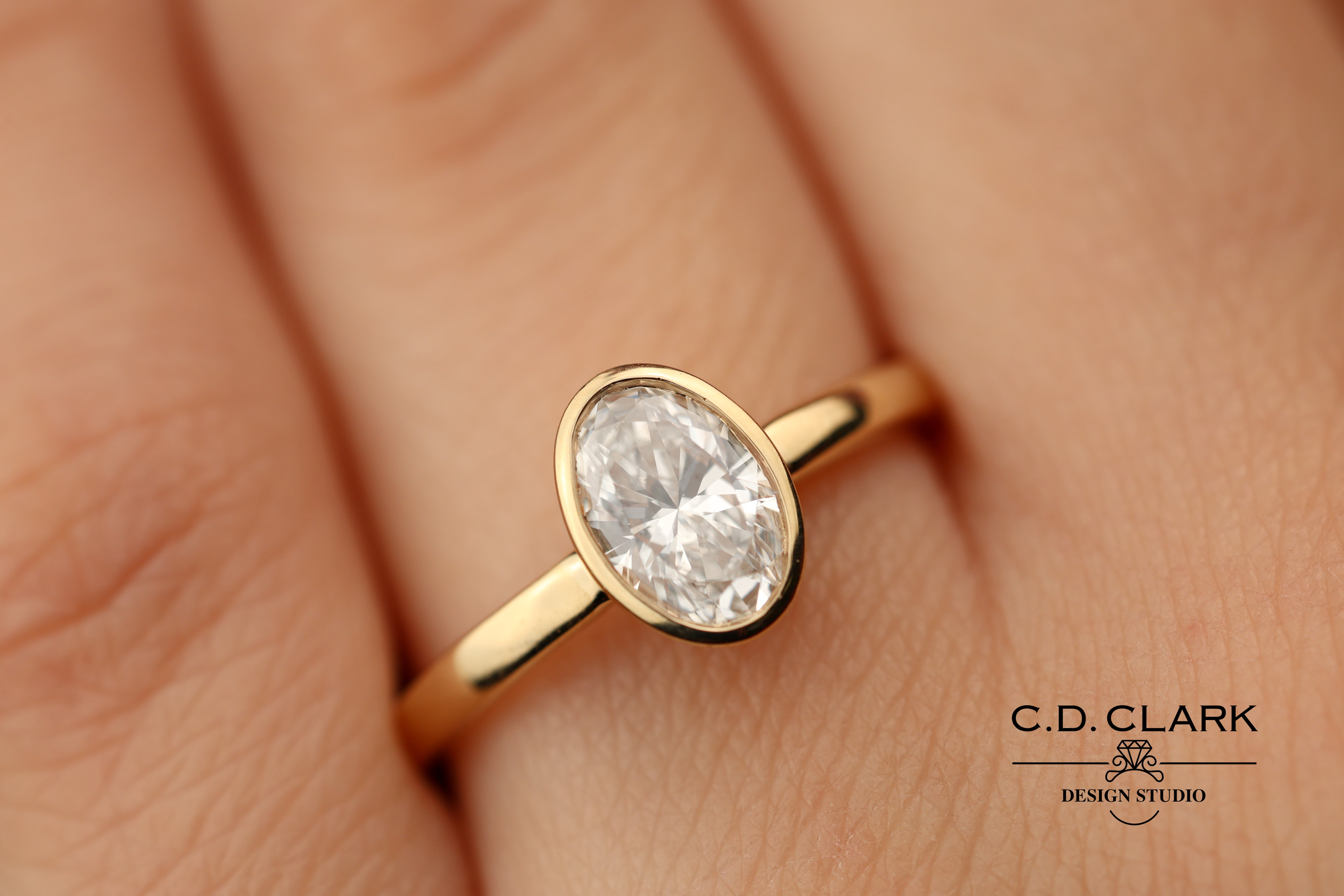 The Aria Oval Yellow Gold Bezel Set Engagement Ring