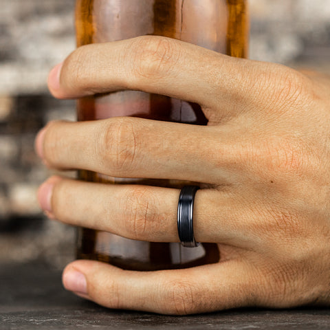 man wearing black titanium Satin center, polished round edges wedding band